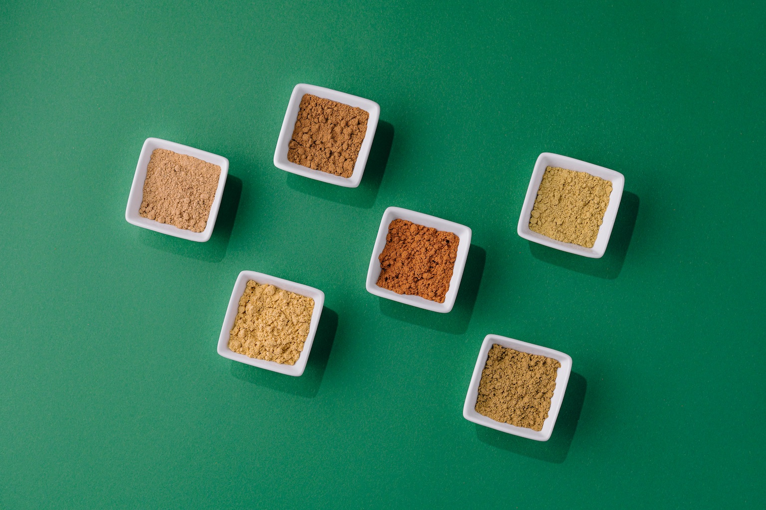 Various seed flours in white dishes