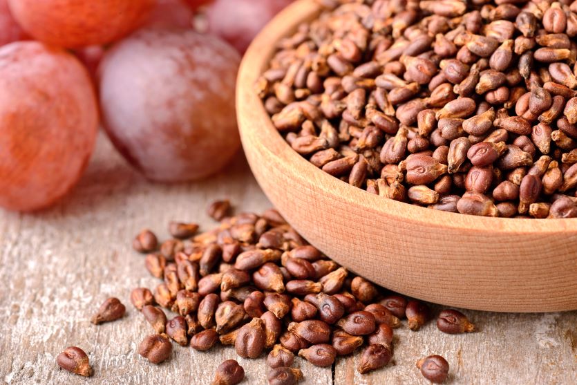 Grape seeds in wooden bowl